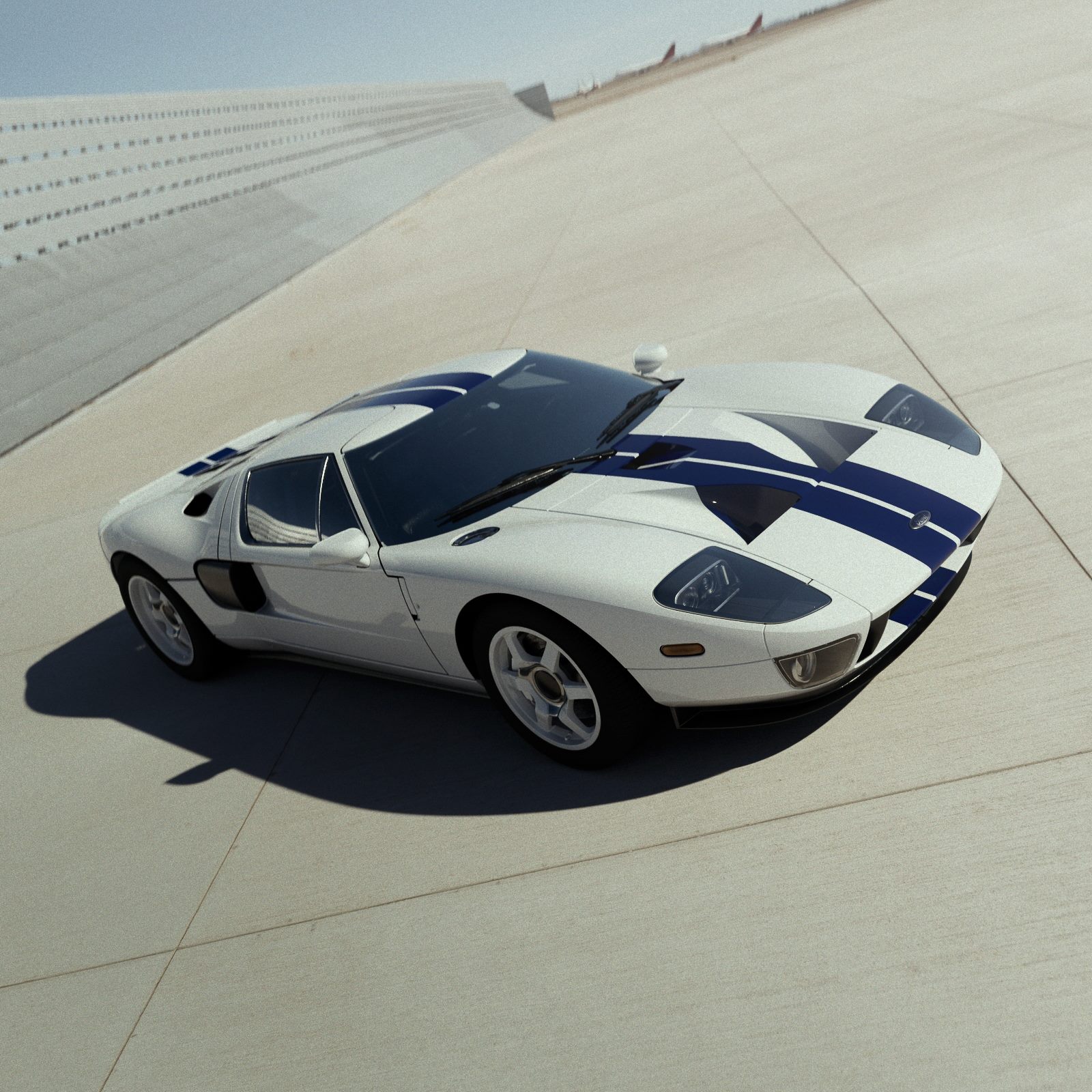 White Ford GT with blue stripes on a sloped concrete track