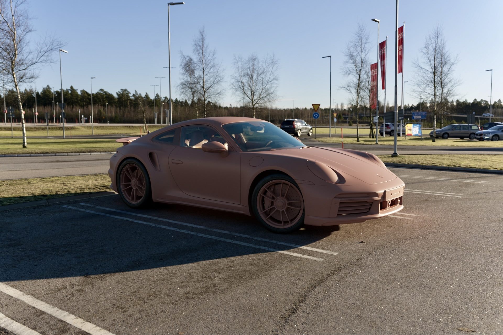 The same car park scene with the car rendered in a single clay-coloured material
