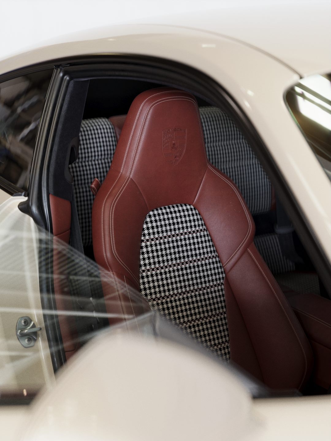 Open door showing a red leather seat with houndstooth fabric inserts