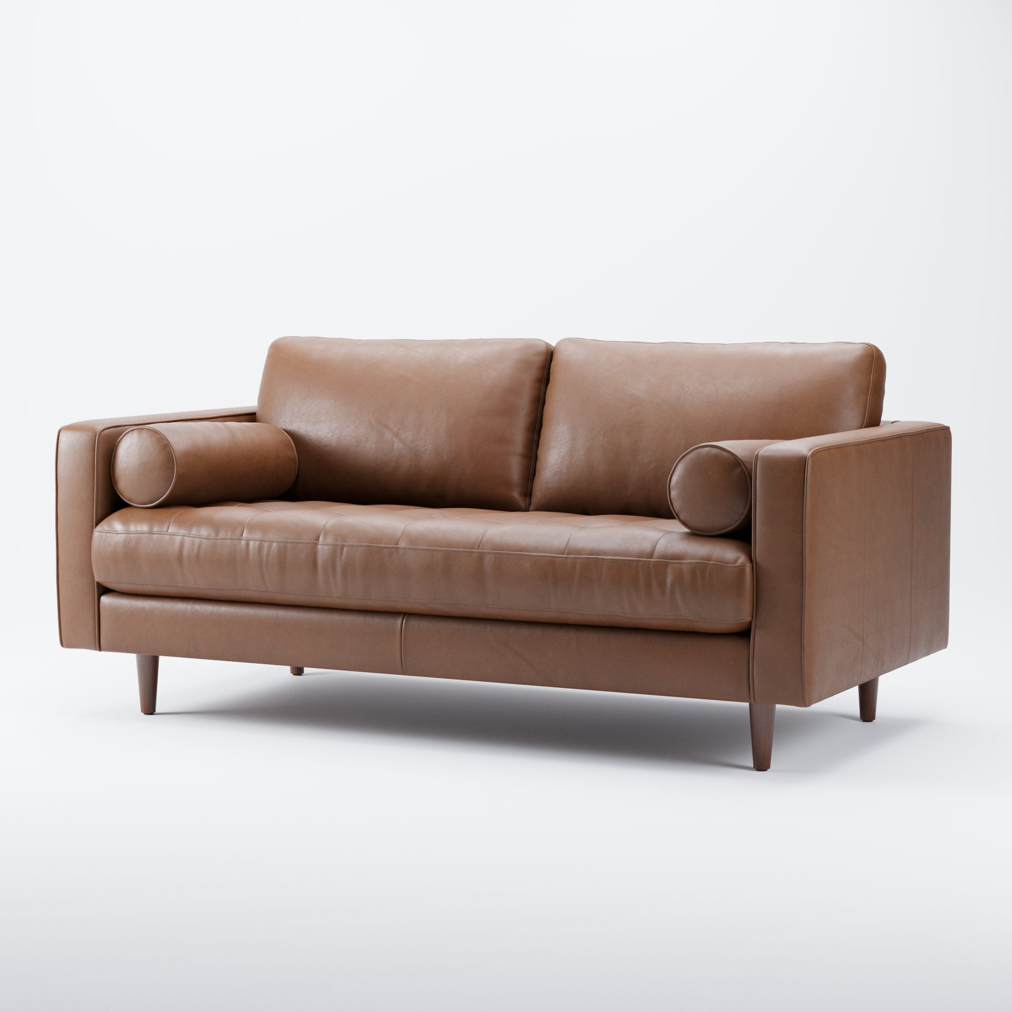 Tan leather two-seat sofa with bolster cushions on a pale grey background