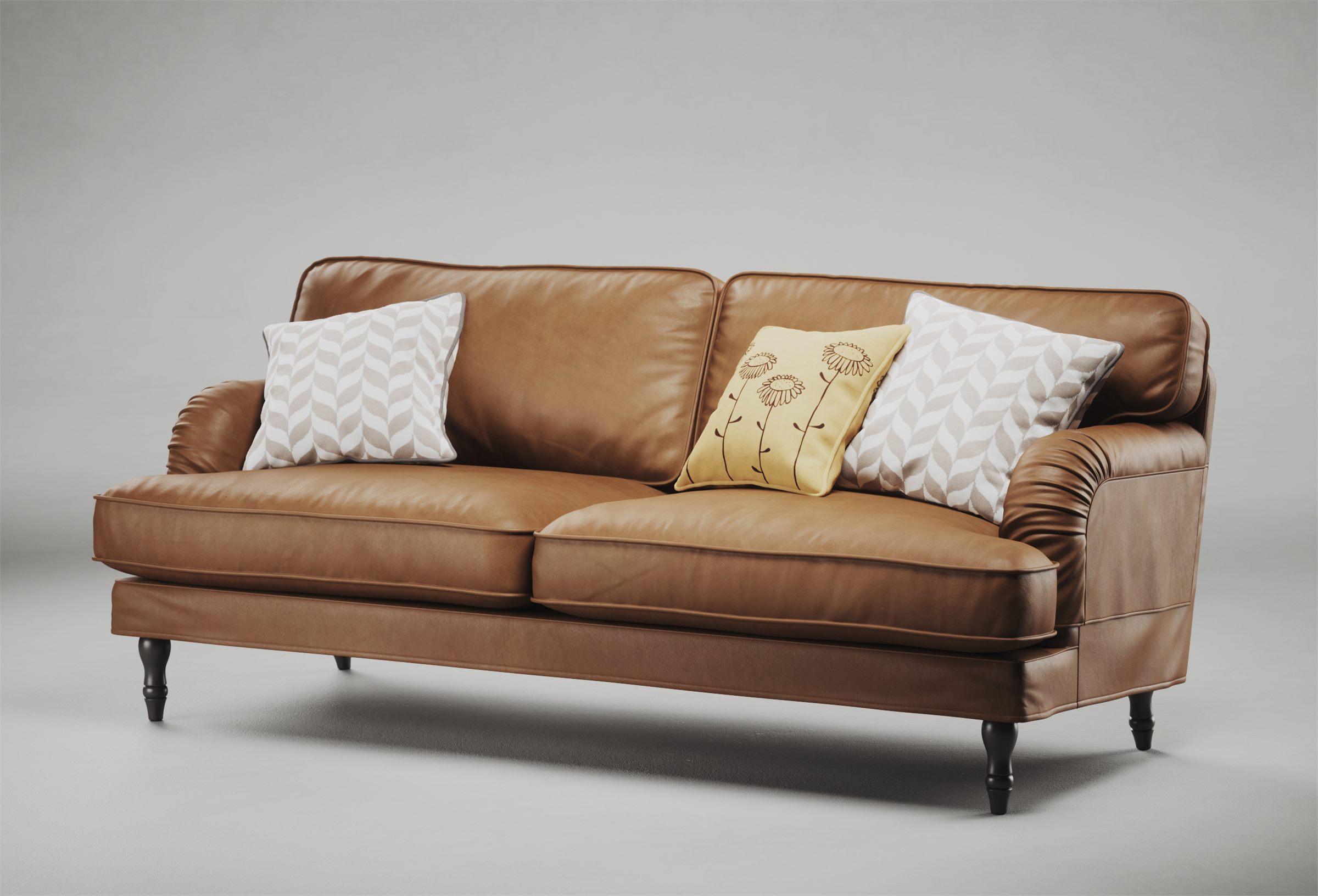 Brown leather sofa with patterned cushions on a light grey background