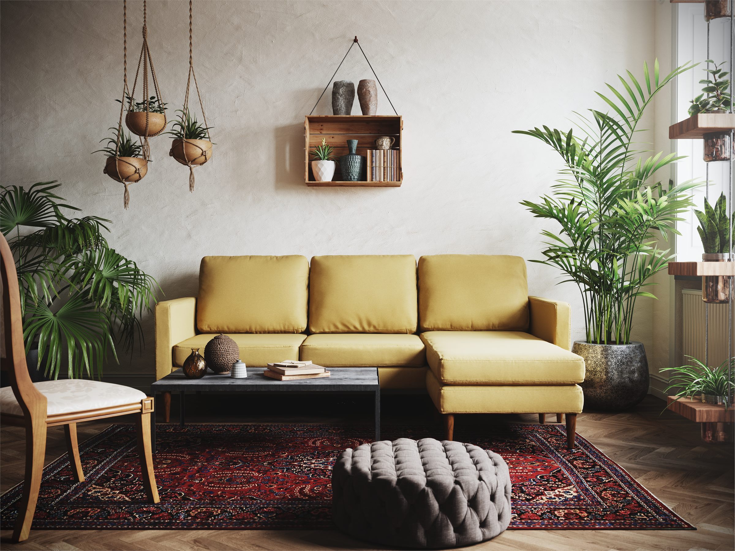 Living room with a yellow sectional sofa, hanging plants, a patterned rug and a tufted pouf