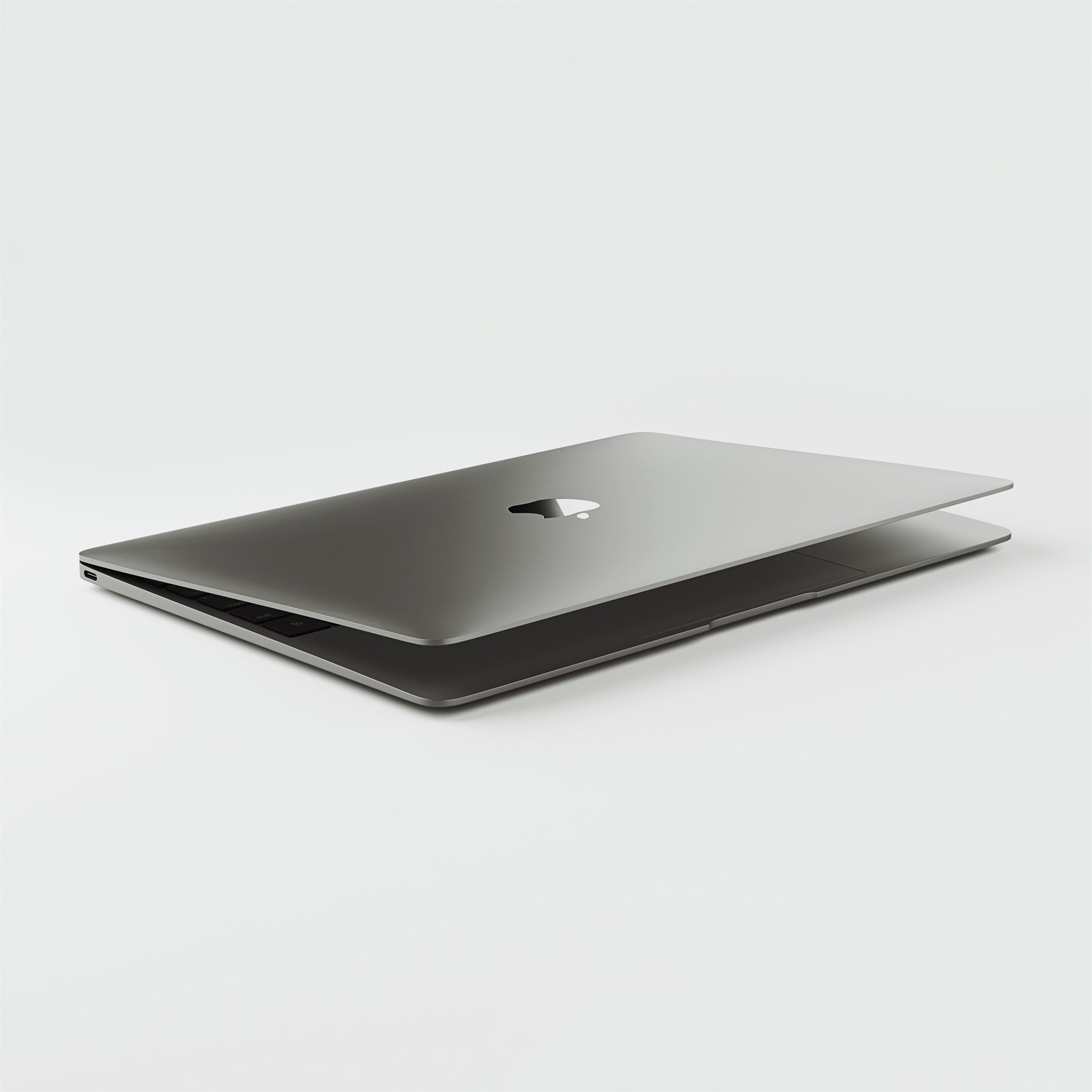 Closed silver laptop on a white surface
