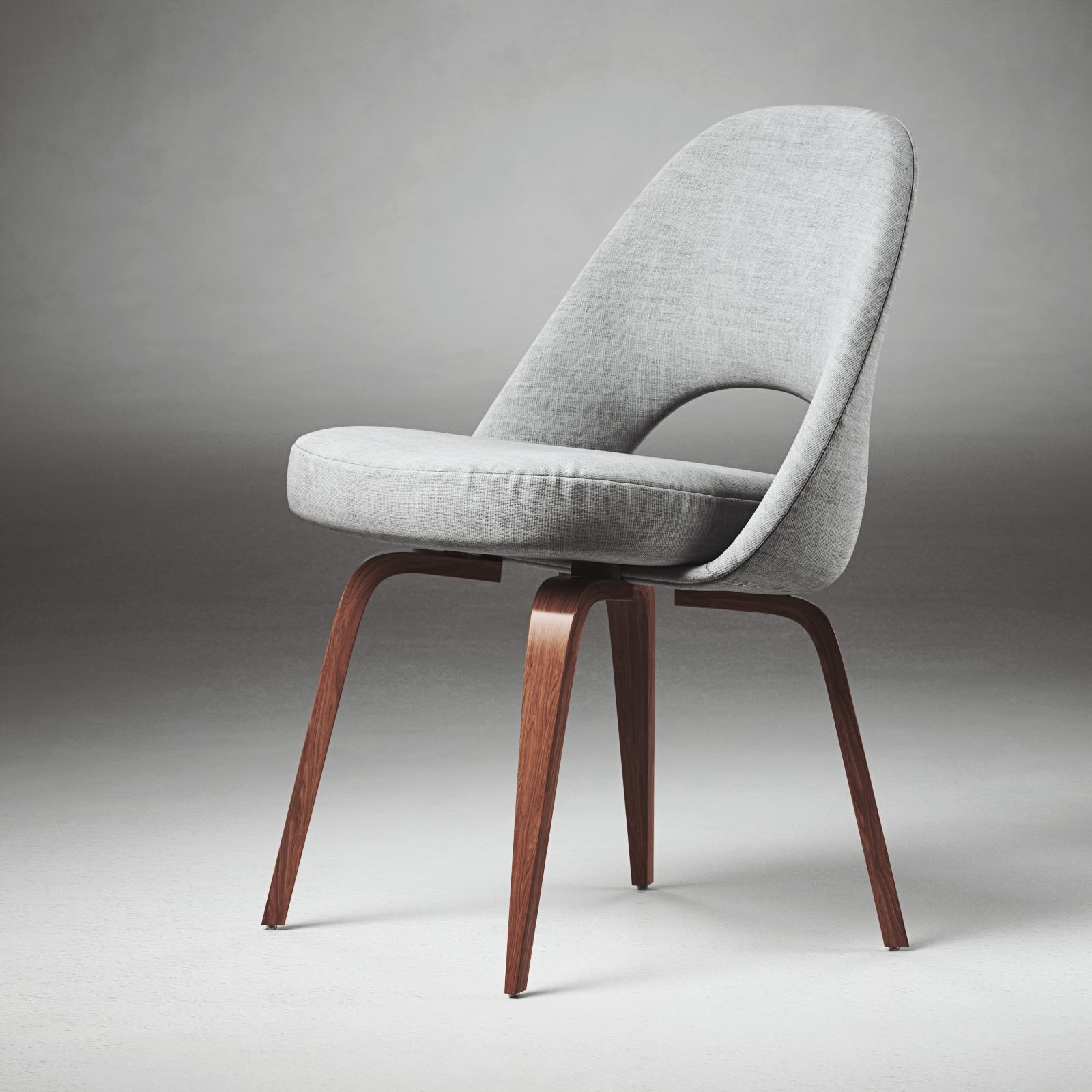 Grey upholstered chair with wooden legs in a grey studio