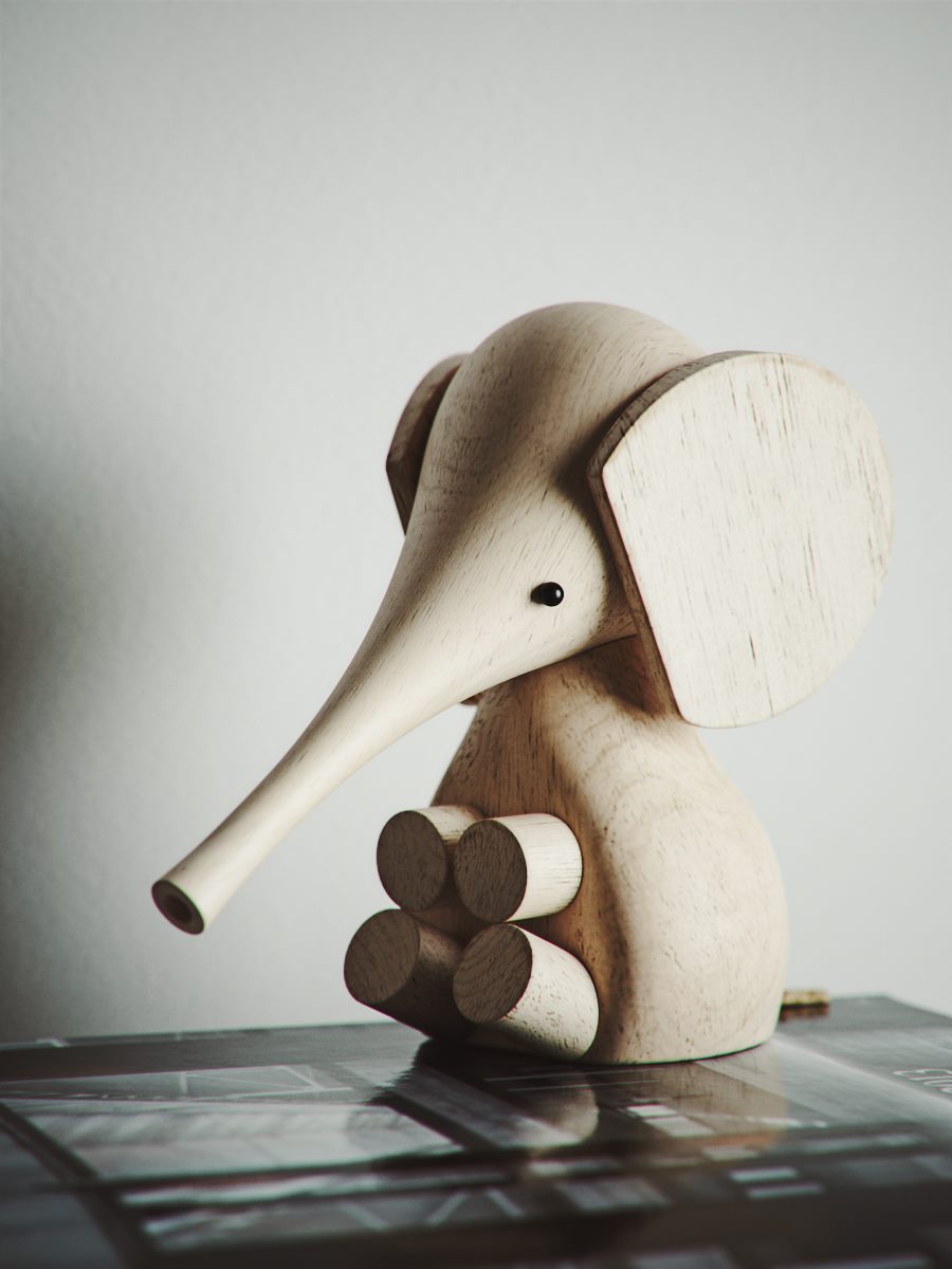 Wooden toy elephant on a dark surface