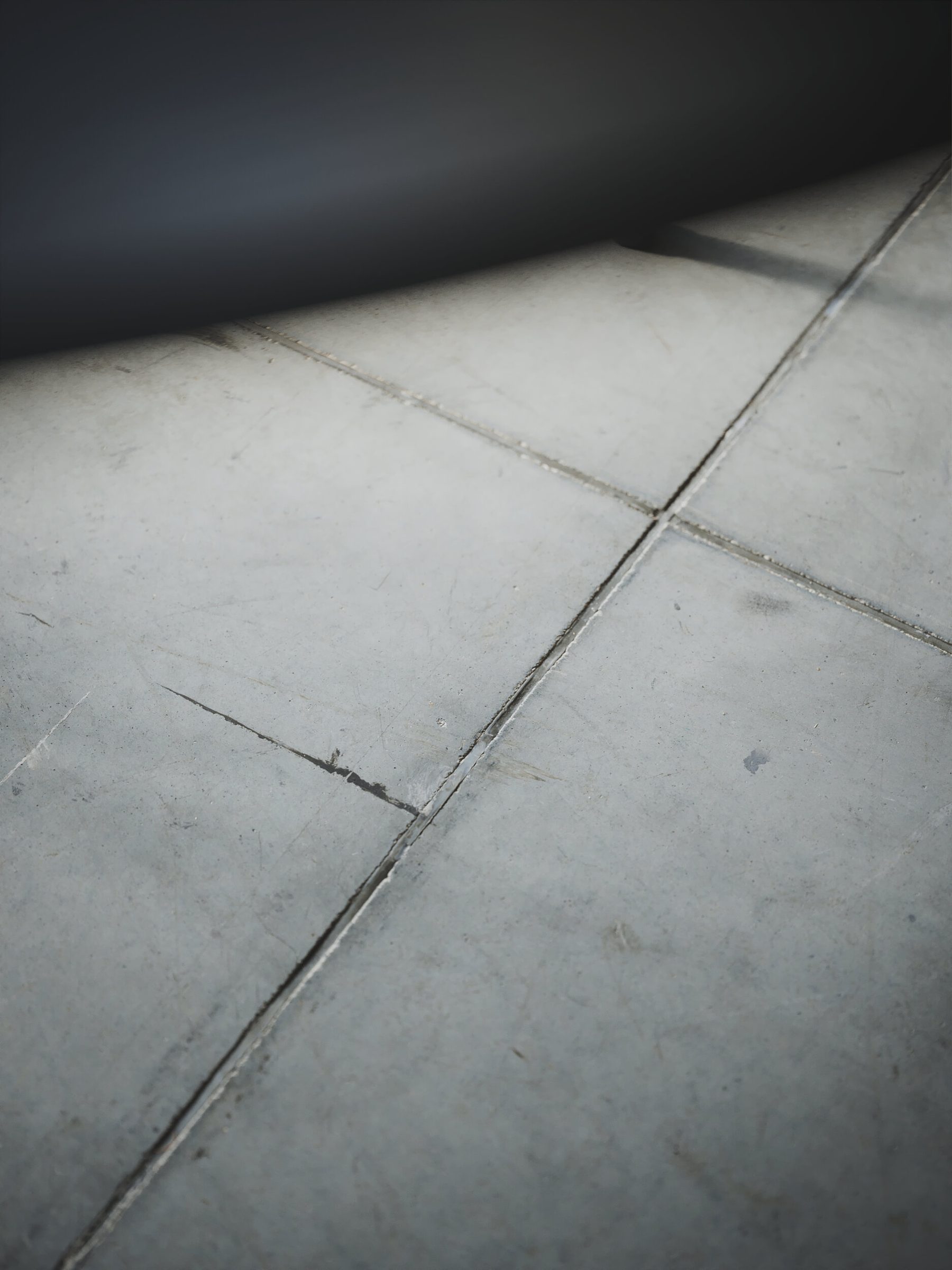 Concrete floor tiles in soft light, close up