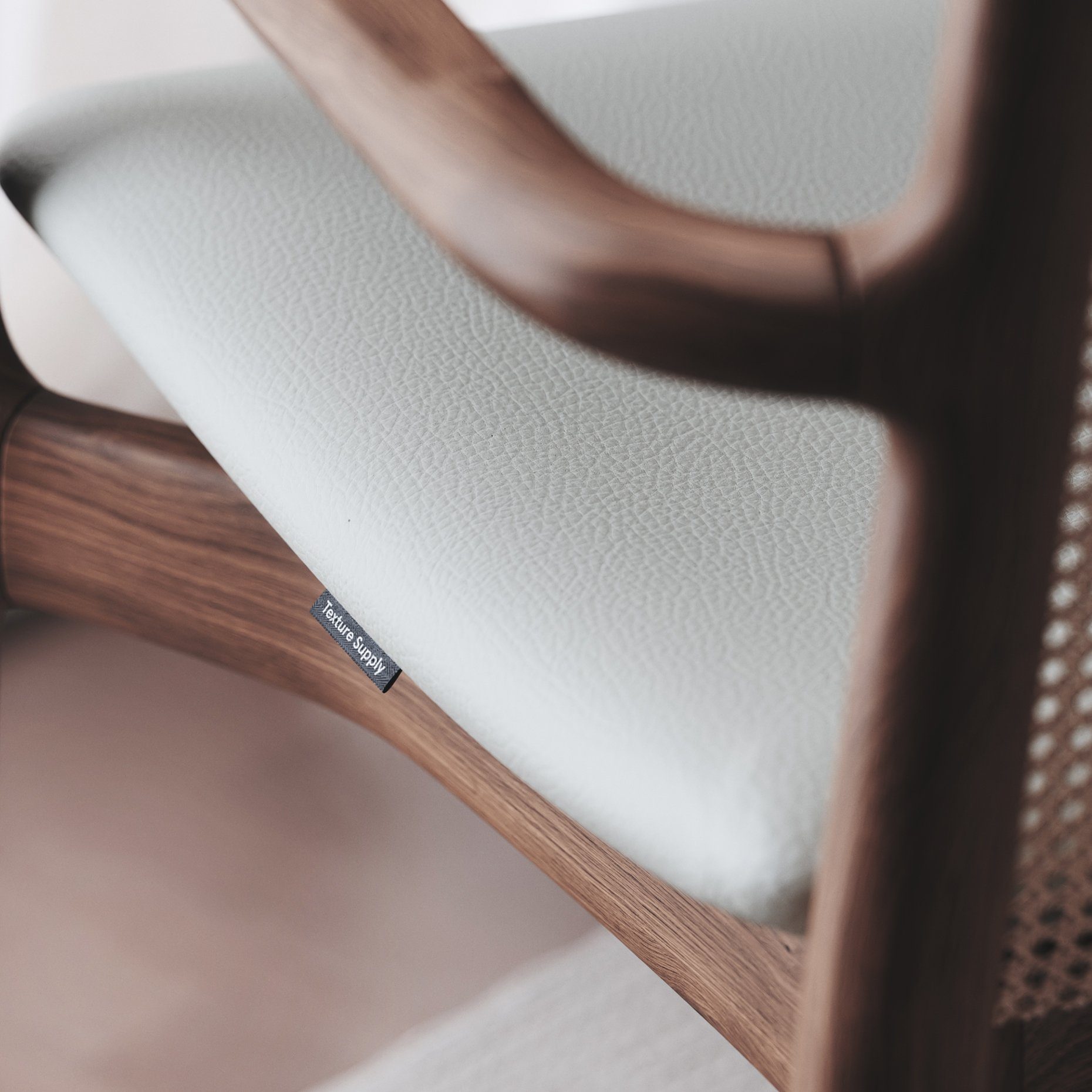 Wooden chair with a pale leather seat, close up
