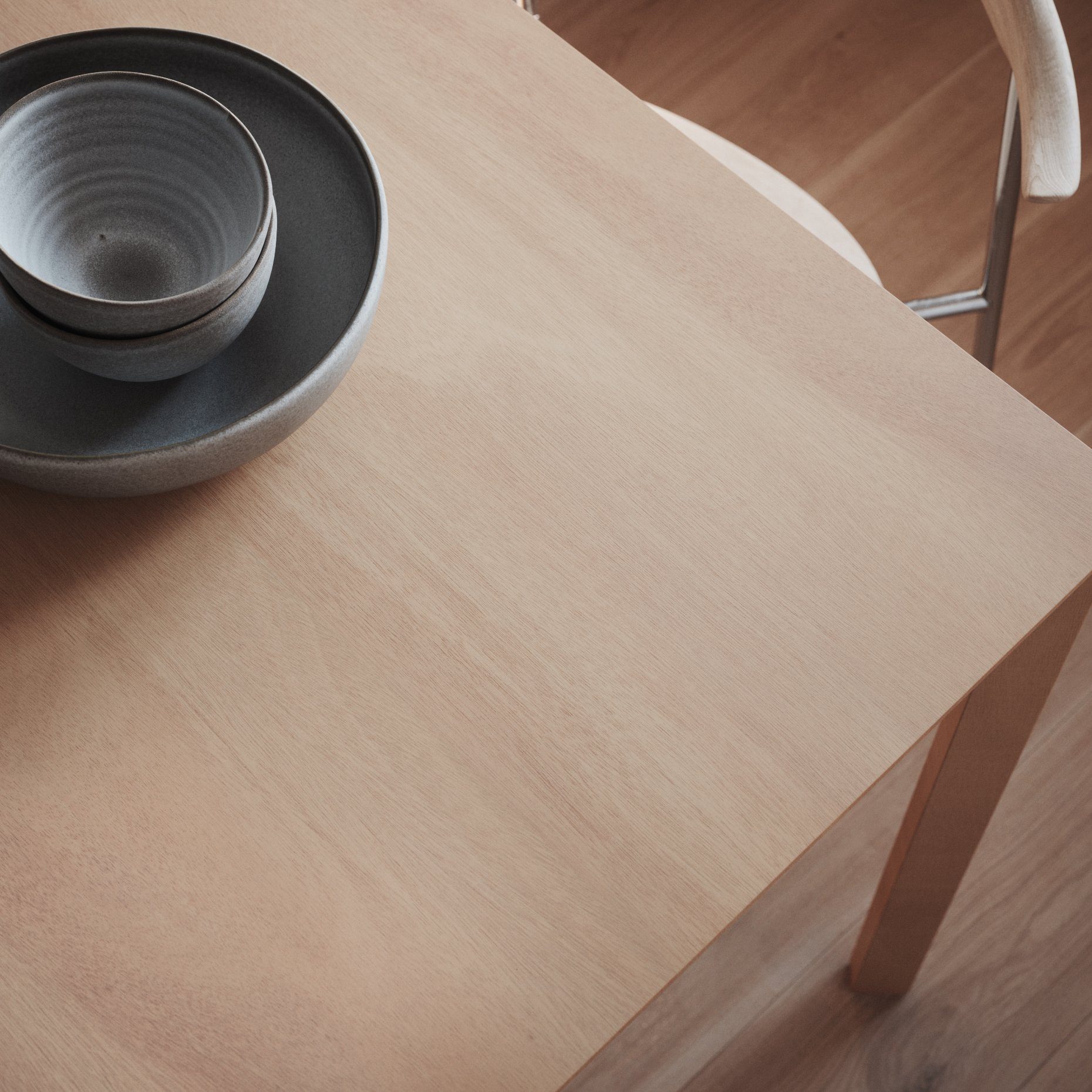 Light wood veneer tabletop with a small dark bowl